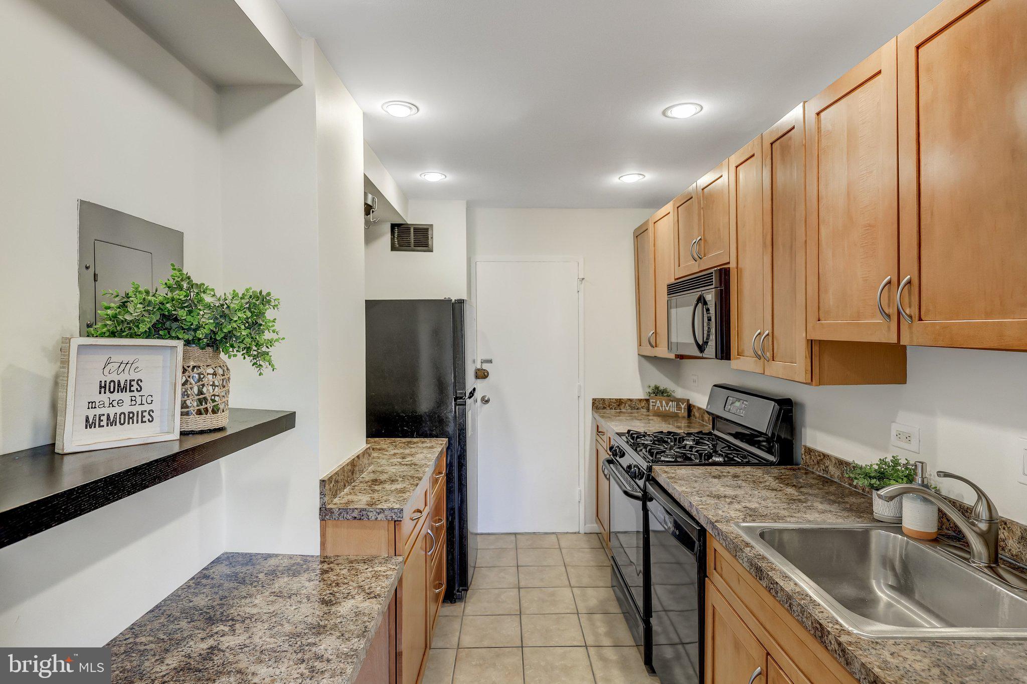 1900 Lyttonsville Road, Unit 504 Silver Spring, MD 20910 - Photo 8 of 16 a kitchen with stainless steel appliances granite countertop a sink stove and refrigerator