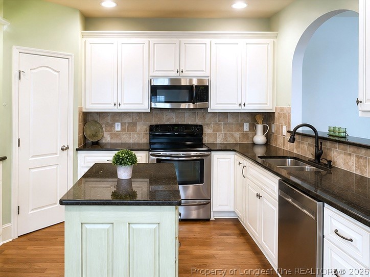 175 Pine Hawk Drive Spring Lake, NC 28390 - Photo 9 of 43 a kitchen with granite countertop white cabinets and stainless steel appliances