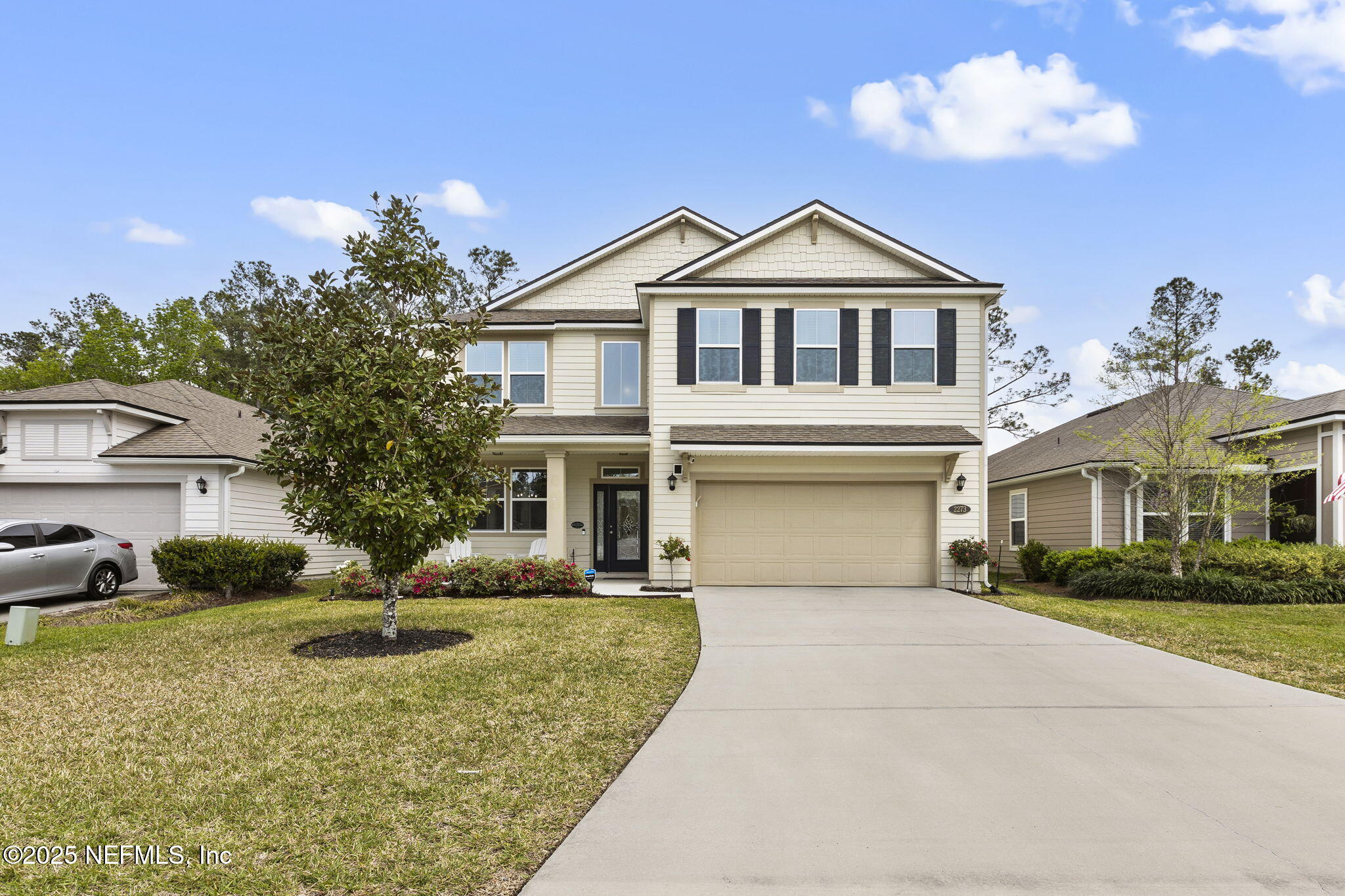 a front view of a house with a yard and garage