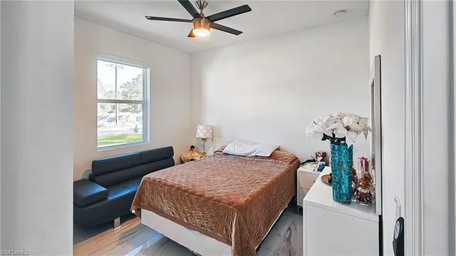 a bedroom with a bed and a window