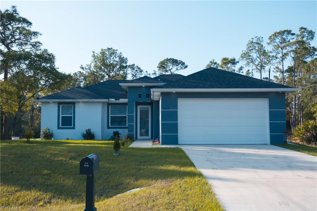 1503 West 17th Street Lehigh Acres, FL 33972 - Photo 2 of 26 a front view of a house with garden