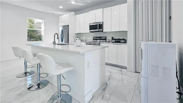 a kitchen with stainless steel appliances a refrigerator and a stove top oven