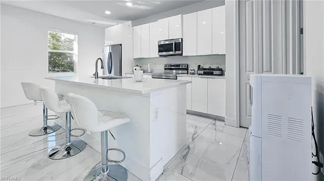 a kitchen with stainless steel appliances a refrigerator and a stove top oven