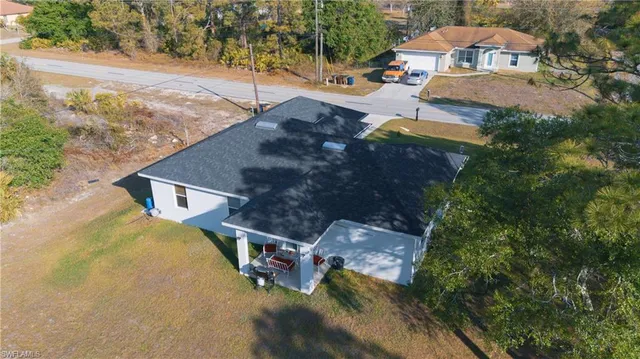 an aerial view of a house with yard swimming pool and outdoor seating