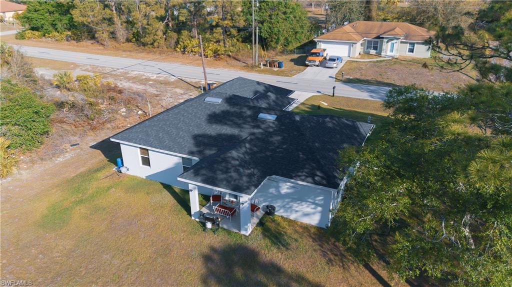 1503 West 17th Street Lehigh Acres, FL 33972 - Photo 24 of 26 an aerial view of a house with yard swimming pool and outdoor seating