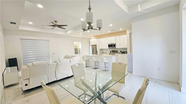 a view of a kitchen with furniture and a ceiling fan