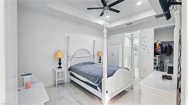 a living room with a bed and a chandelier