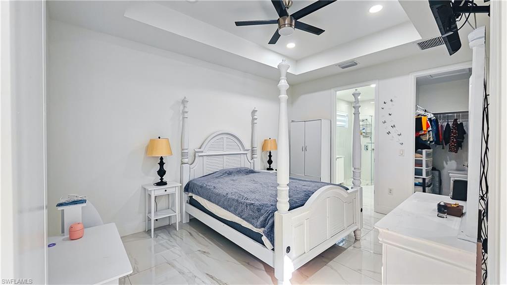 1503 West 17th Street Lehigh Acres, FL 33972 - Photo 9 of 26 a living room with a bed and a chandelier