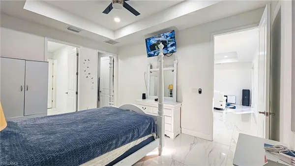 a spacious bedroom with a bed and a walk in closet