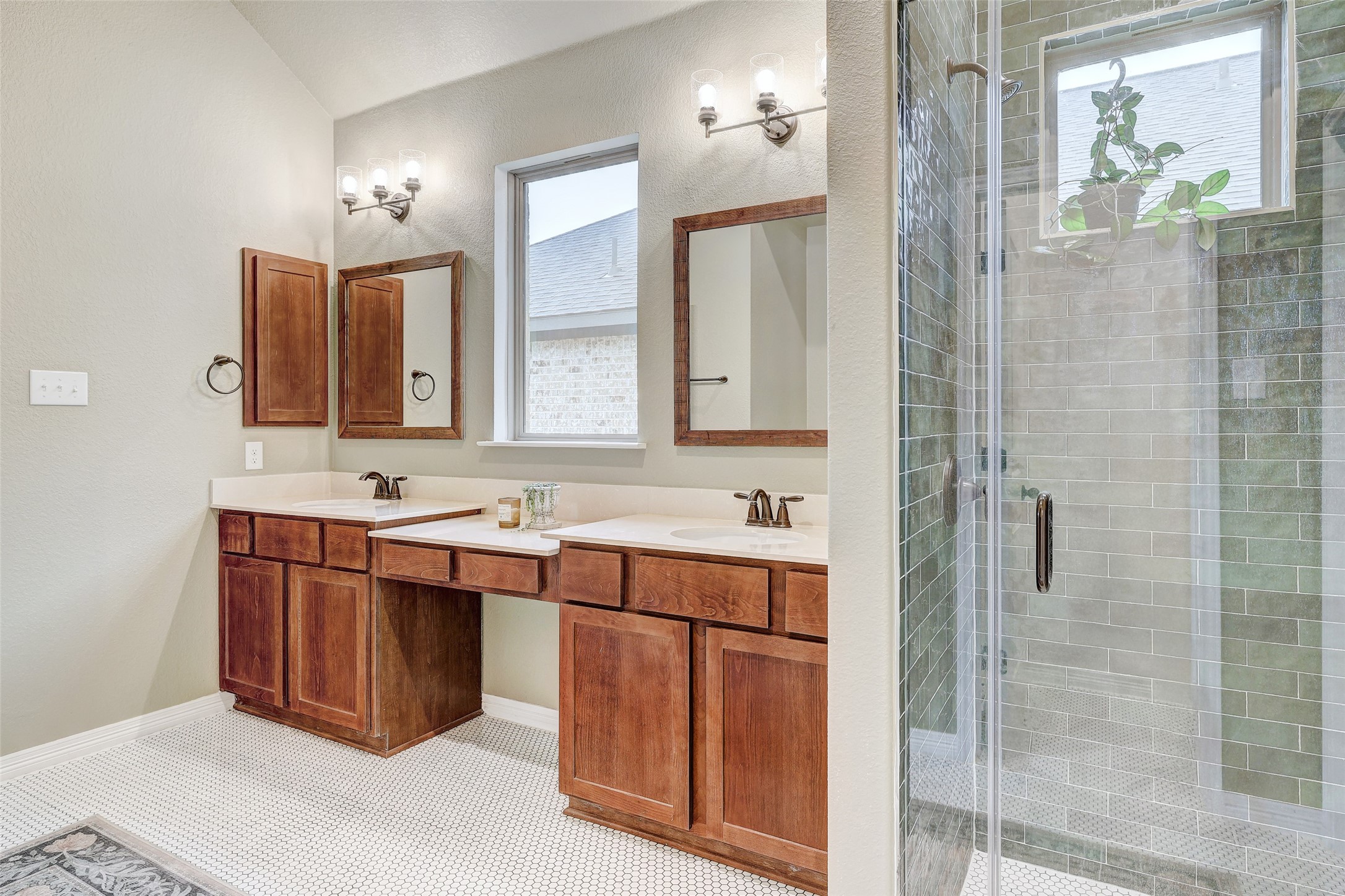 1117 Spring Gulch Lane Georgetown, TX 78628 - Photo 26 of 39 Dual vanity sinks provide ample space in this well-appointed primary bathroom, featuring a glass-enclosed shower.