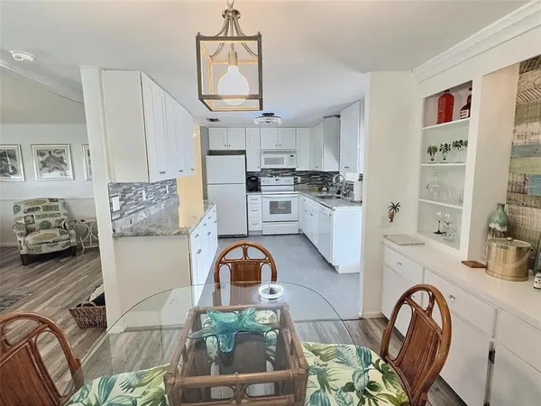a bathroom with a granite countertop sink a mirror a vanity and a shower
