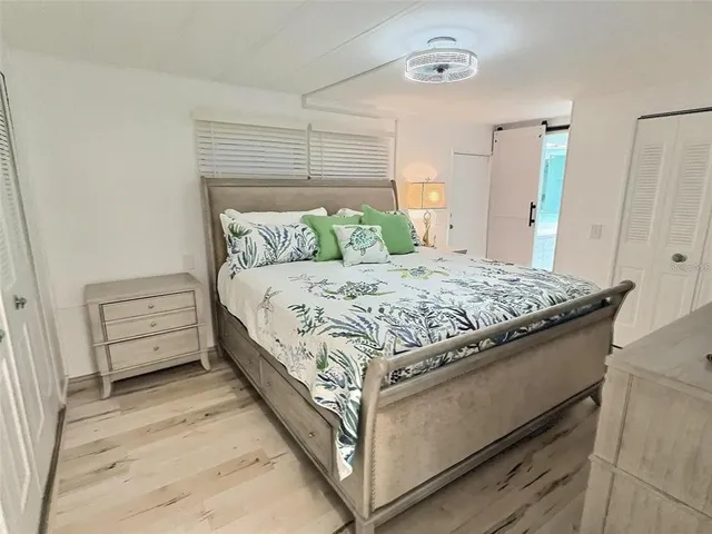 a dining room with furniture a chandelier and wooden floor