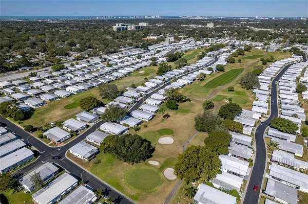 a view of large house with a big yard and large trees