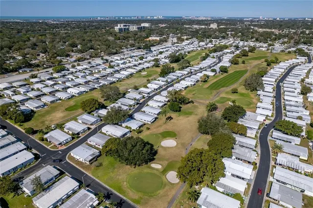 a view of large house with a big yard and large trees
