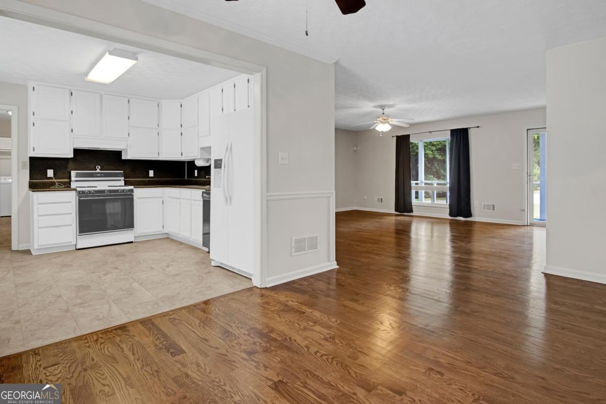 145 Deer Ridge Court McDonough, GA 30252 - Photo 12 of 54 a view of a kitchen with wooden floor