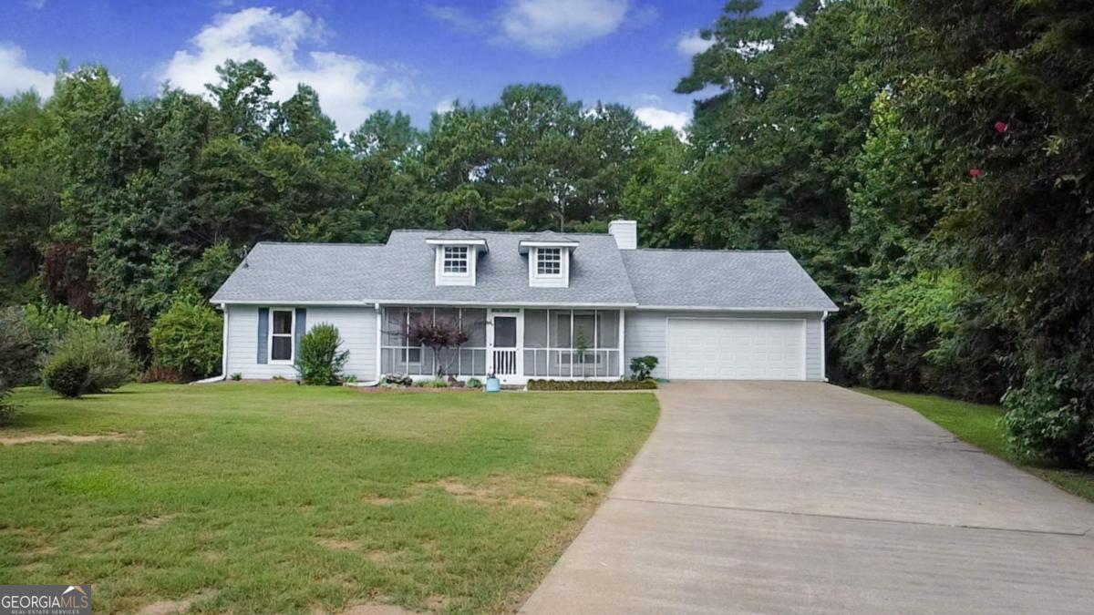 145 Deer Ridge Court McDonough, GA 30252 - Photo 2 of 54 a front view of a house with a garden and trees