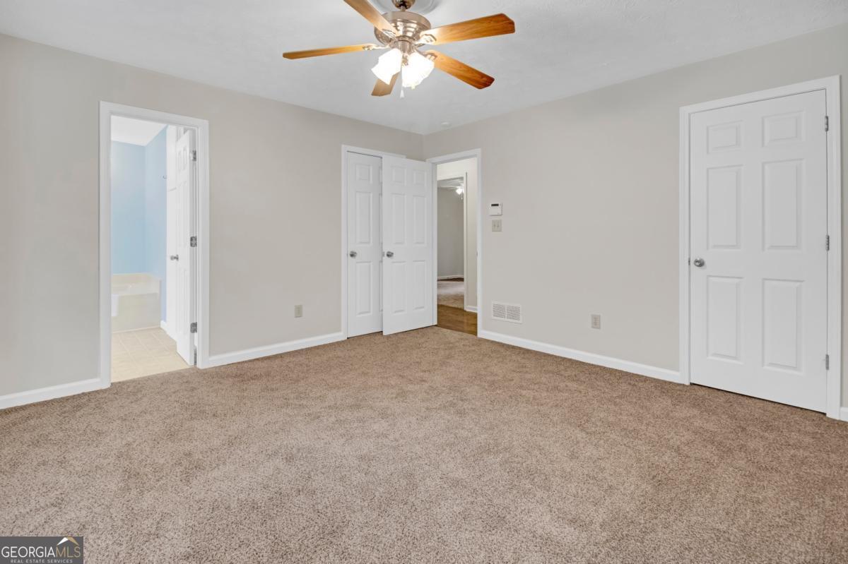 145 Deer Ridge Court McDonough, GA 30252 - Photo 23 of 54 a view of an empty room and chandelier fan