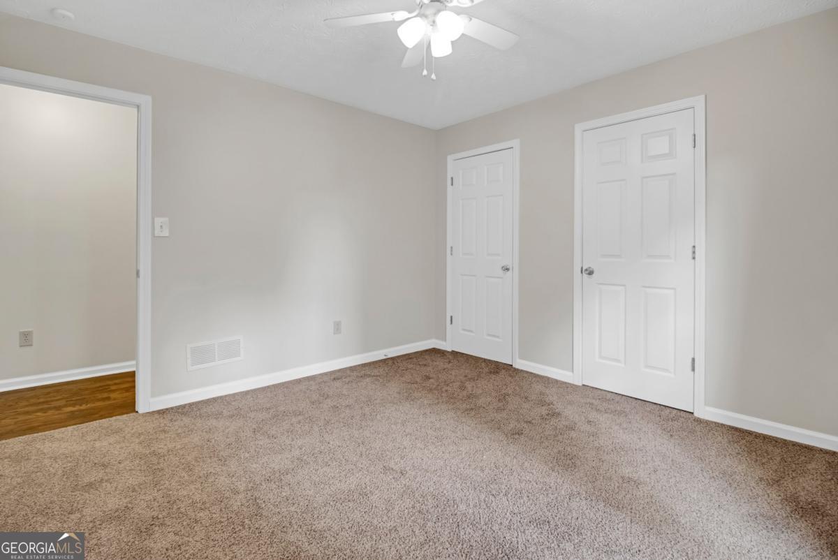 145 Deer Ridge Court McDonough, GA 30252 - Photo 29 of 54 a view of an empty room with a chandelier fan