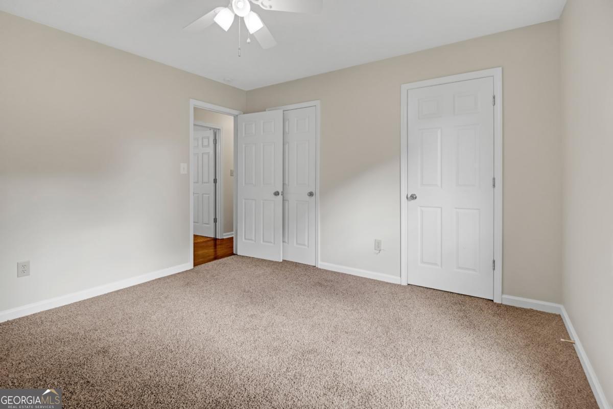 145 Deer Ridge Court McDonough, GA 30252 - Photo 32 of 54 a view of an empty room and chandelier fan