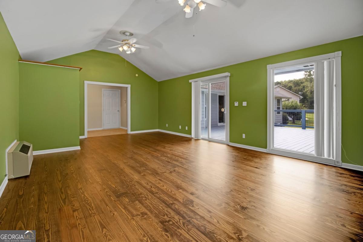 145 Deer Ridge Court McDonough, GA 30252 - Photo 37 of 54 a view of a big room with wooden floor and windows