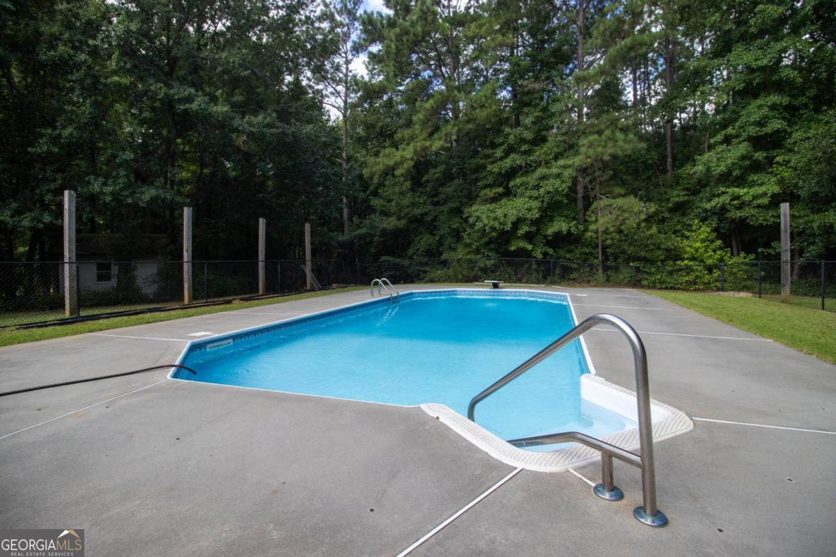 145 Deer Ridge Court McDonough, GA 30252 - Photo 40 of 54 a view of a swimming pool with an outdoor space and seating area