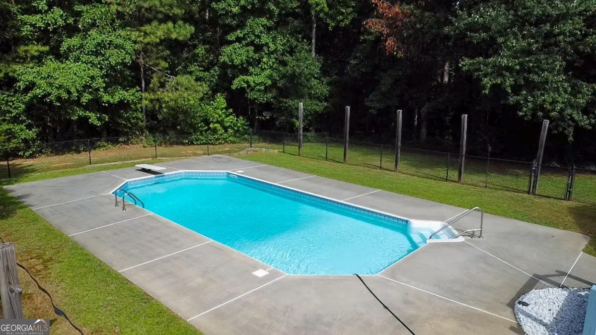 145 Deer Ridge Court McDonough, GA 30252 - Photo 41 of 54 a view of a swimming pool with a yard