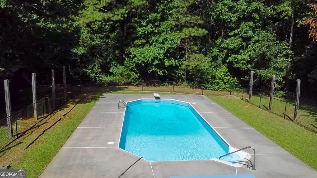 145 Deer Ridge Court McDonough, GA 30252 - Photo 42 of 54 a view of yard with swimming pool and trees in the background