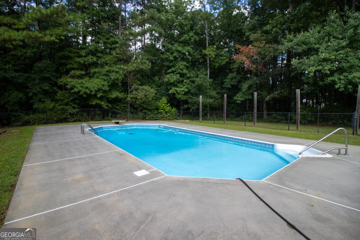 145 Deer Ridge Court McDonough, GA 30252 - Photo 43 of 54 a view of a swimming pool with an outdoor space and seating area