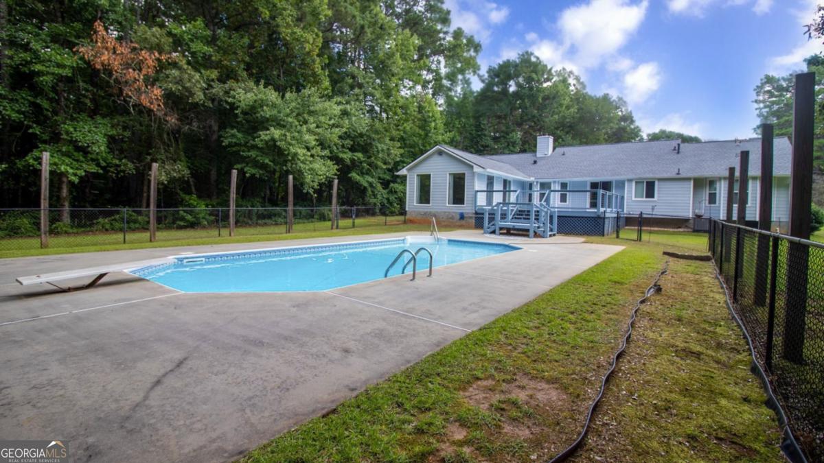 145 Deer Ridge Court McDonough, GA 30252 - Photo 44 of 54 a view of a house with swimming pool and a yard