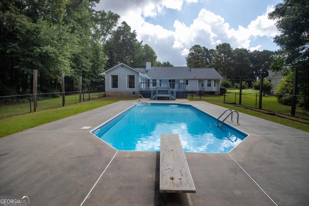 145 Deer Ridge Court McDonough, GA 30252 - Photo 48 of 54 a view of a house with pool and a yard