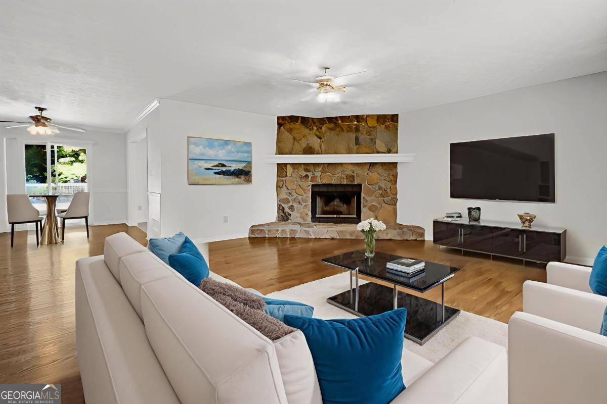 145 Deer Ridge Court McDonough, GA 30252 - Photo 5 of 54 a living room with furniture wooden floor and a flat screen tv
