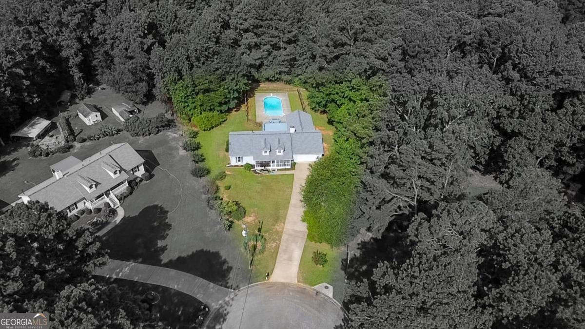 145 Deer Ridge Court McDonough, GA 30252 - Photo 51 of 54 an aerial view of a house with a yard and large trees