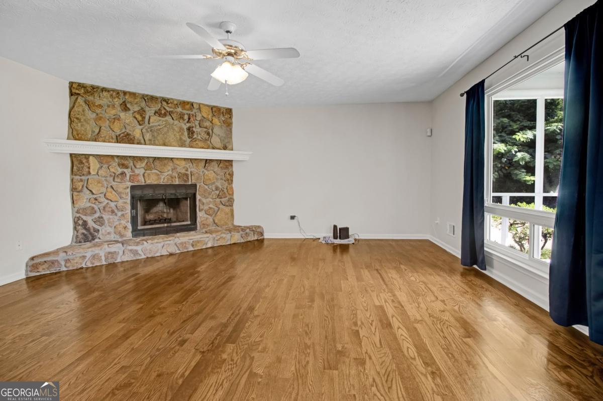 145 Deer Ridge Court McDonough, GA 30252 - Photo 9 of 54 wooden floor fireplace and windows in an empty room