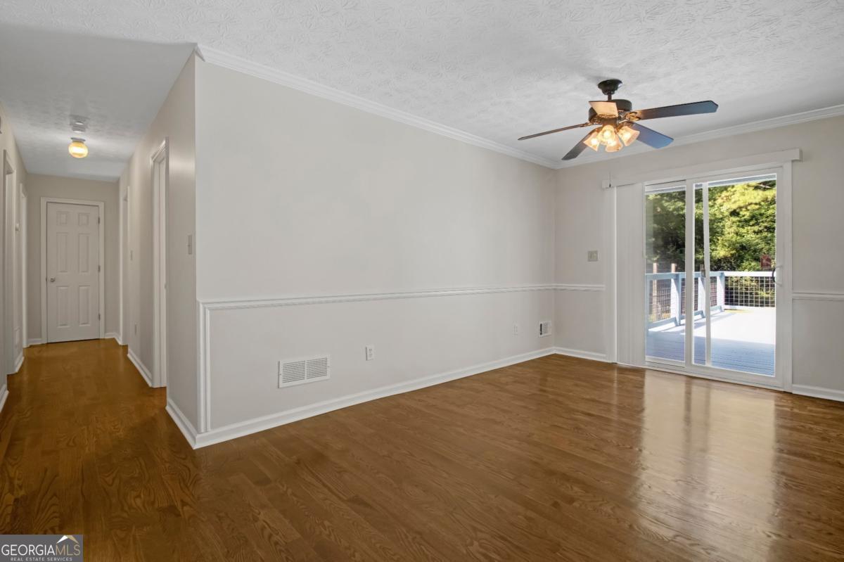 145 Deer Ridge Court McDonough, GA 30252 - Photo 10 of 54 wooden floor in an empty room with a window