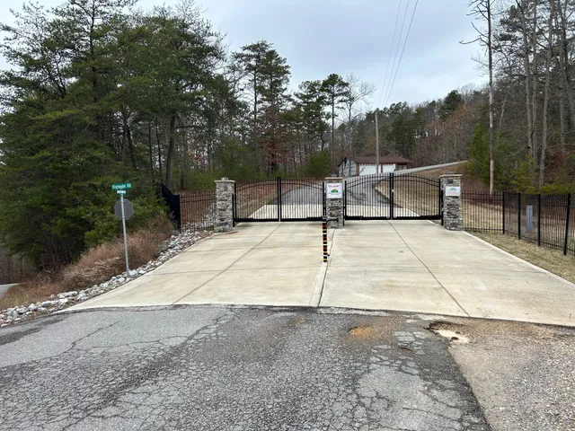 a view of a park with iron fence