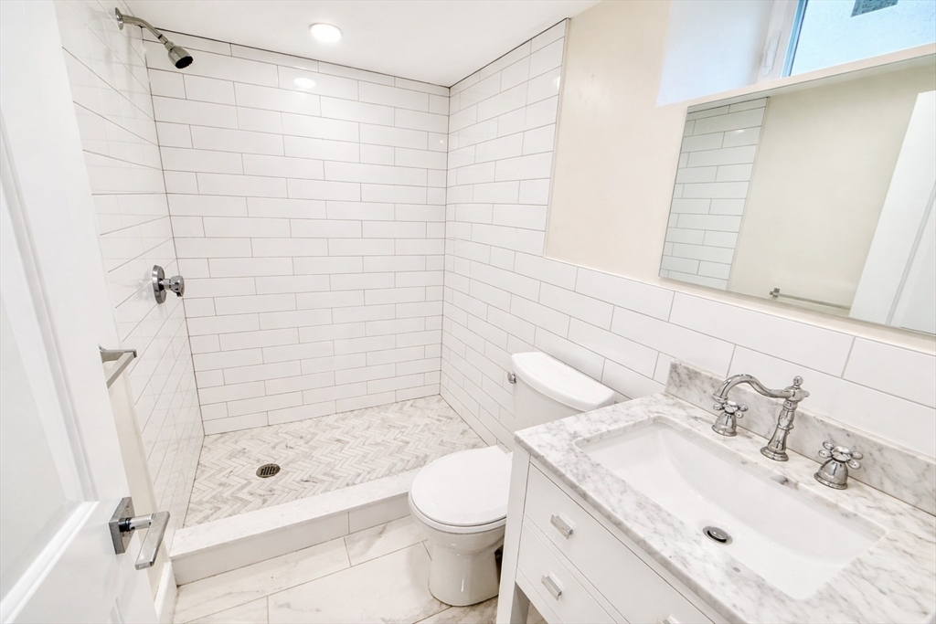 35 Foster Street, Unit A Boston, MA 02135 - Photo 13 of 16 a bathroom with a sink toilet and shower