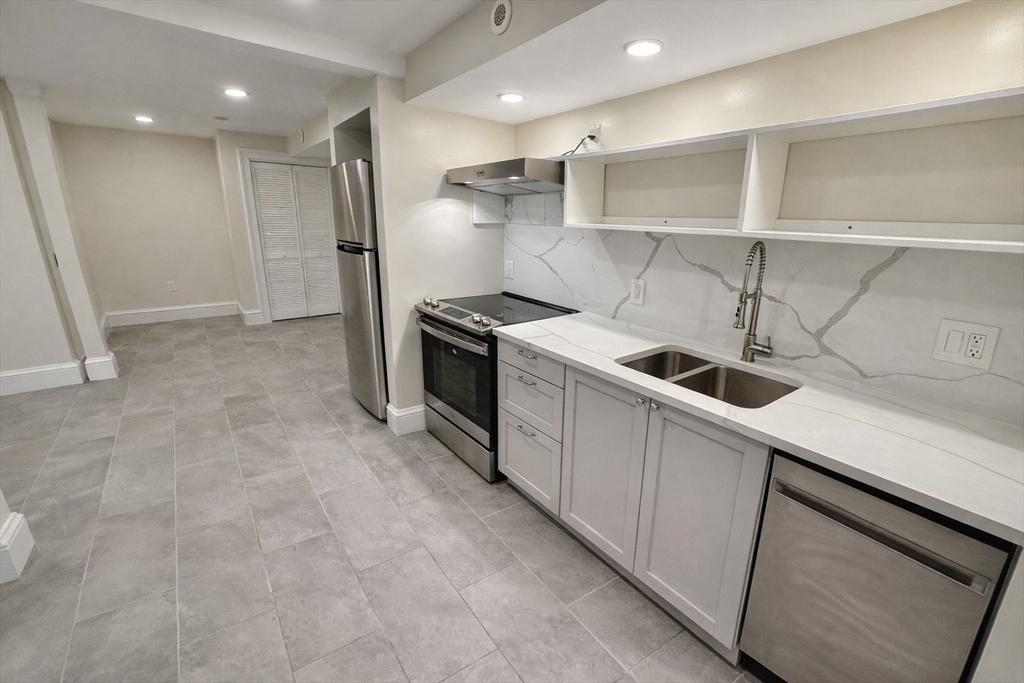 35 Foster Street, Unit A Boston, MA 02135 - Photo 4 of 16 a kitchen with a stove and a refrigerator