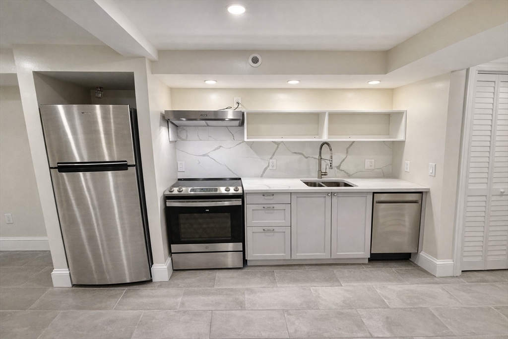 35 Foster Street, Unit A Boston, MA 02135 - Photo 5 of 16 a kitchen with a stove and a refrigerator