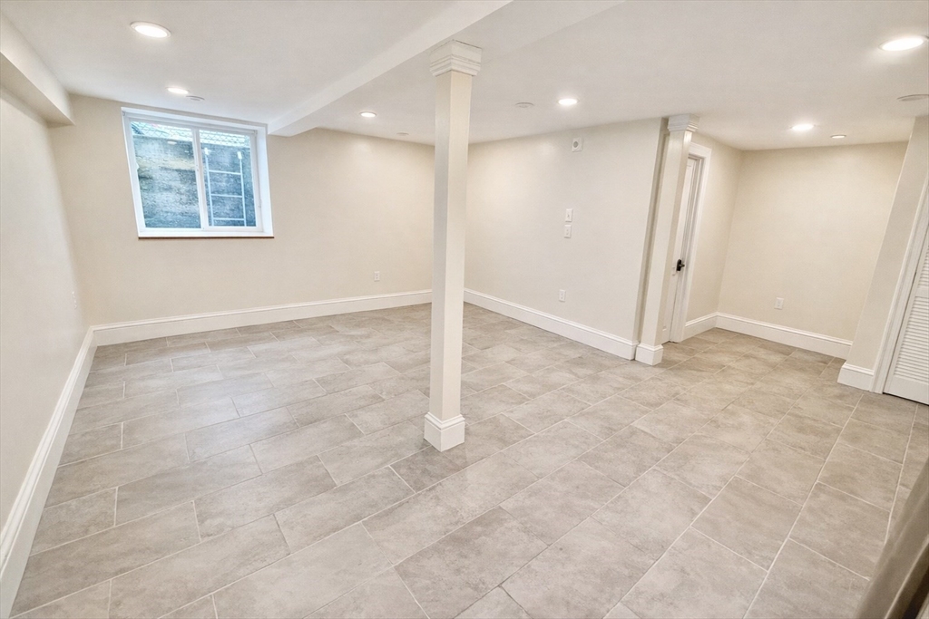 35 Foster Street, Unit A Boston, MA 02135 - Photo 7 of 16 an empty room with windows and closet