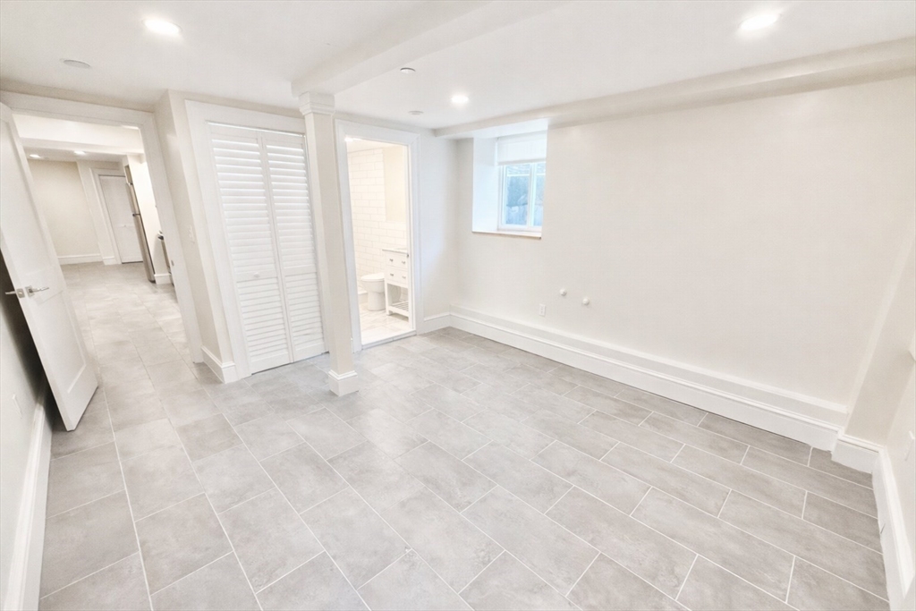 35 Foster Street, Unit A Boston, MA 02135 - Photo 9 of 16 an empty room with windows