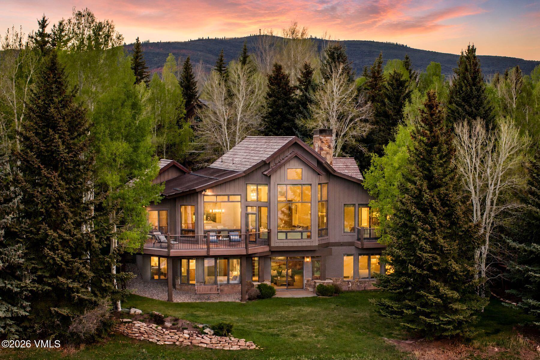 167 Saddle Ridge Edwards, CO 81632 - Photo 1 of 41 a view of a large house with a big yard and large trees