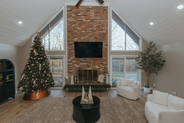 a living room with furniture a window and a fireplace