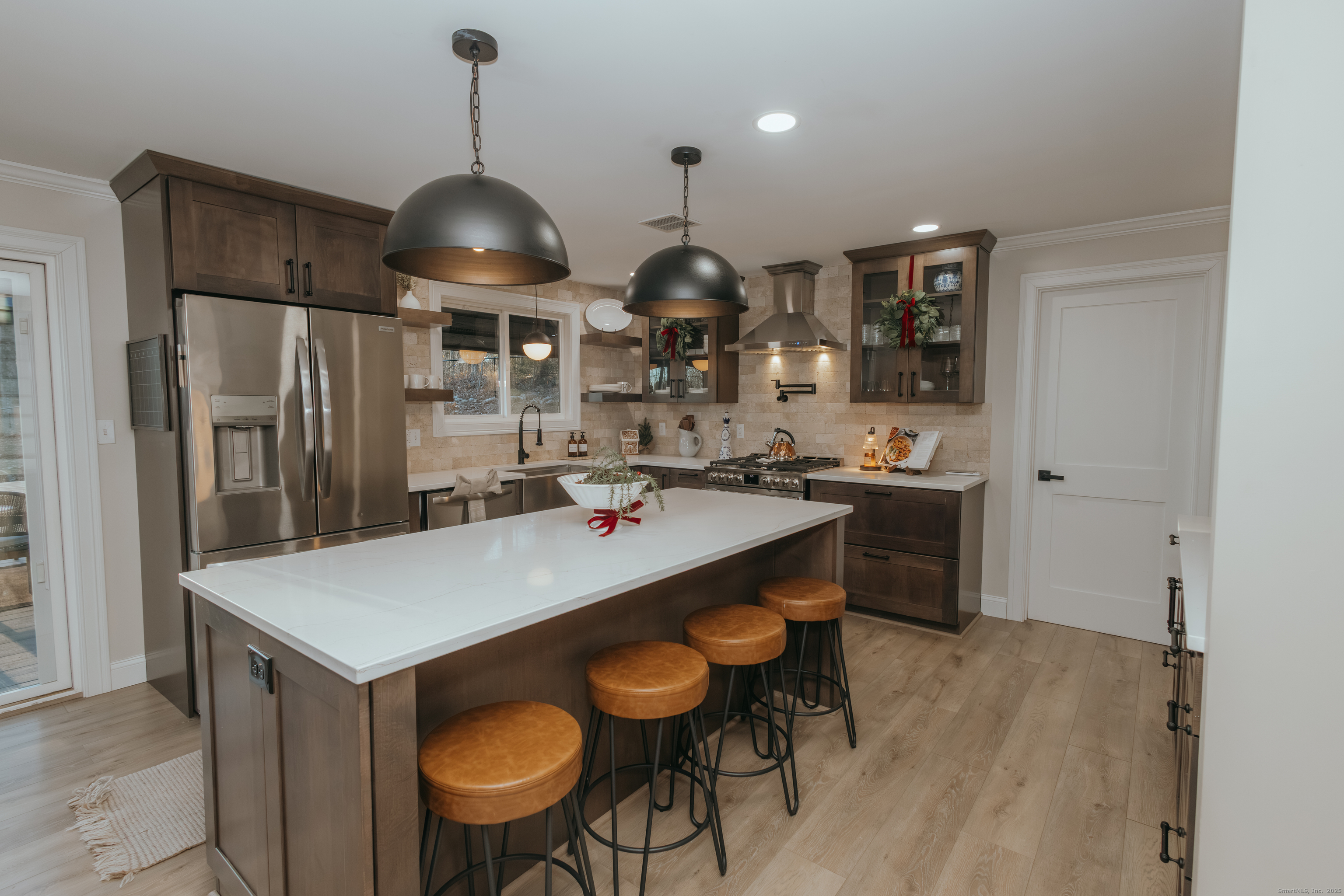 4 Moss Lane Wolcott, CT 06716 - Photo 20 of 40 a kitchen with stainless steel appliances granite countertop a stove a refrigerator a sink a dining table and chairs