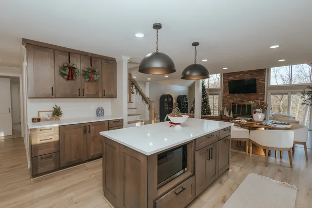 a kitchen with a stove a sink a dining table and chairs