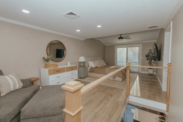 a living room with furniture and a mirror