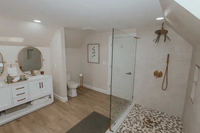 a bathroom with a sink a toilet and shower