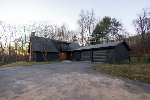 a view of a house with a yard and garage