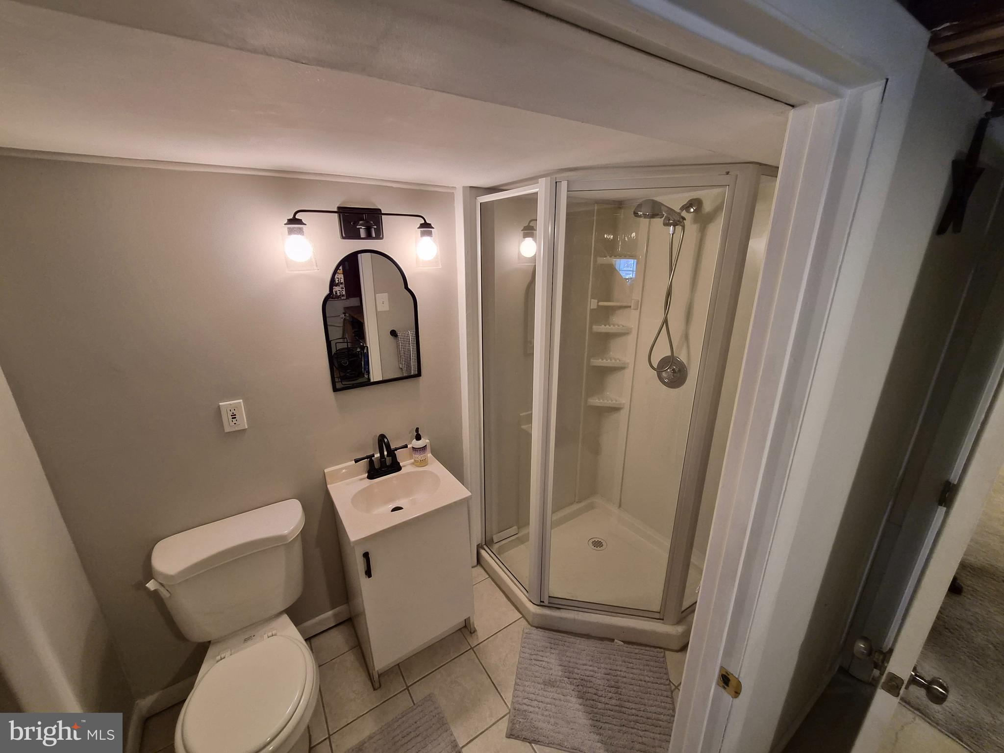 1601 Belt Street Baltimore, MD 21230 - Photo 24 of 30 a bathroom with a toilet sink vanity tub and mirror