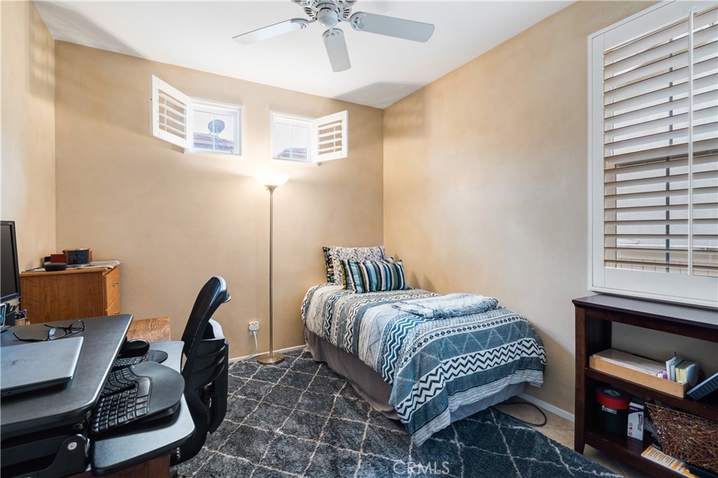 56 Freeland Irvine, CA 92602 - Photo 12 of 28 a bedroom with a bed a desk and chair