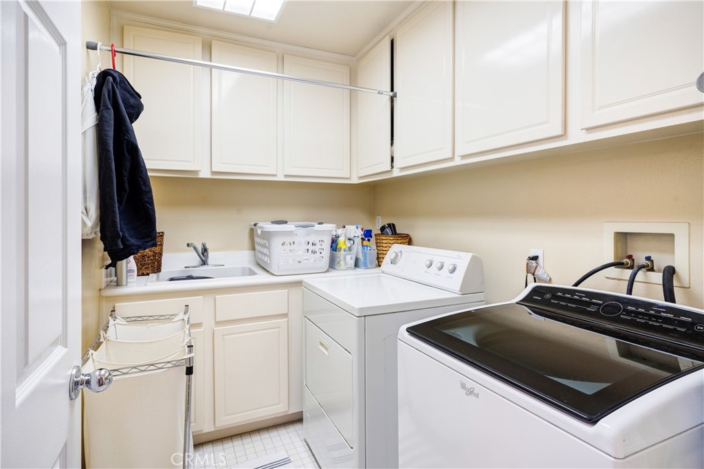 56 Freeland Irvine, CA 92602 - Photo 17 of 28 a kitchen with white cabinets and white appliances